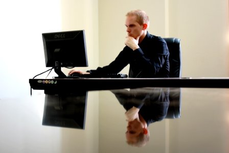 Man Sitting Facing Pc Inside Room photo