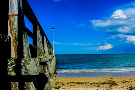 Brown Wooden Bar Near Sea Shore Under Blue Sky During Day Time photo