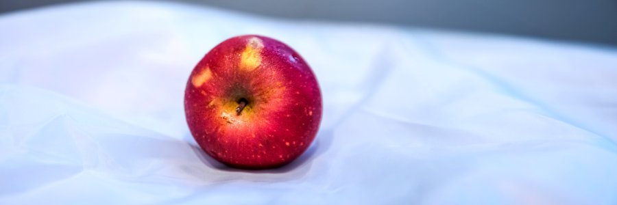 Red Apple Fruit On White Textile photo