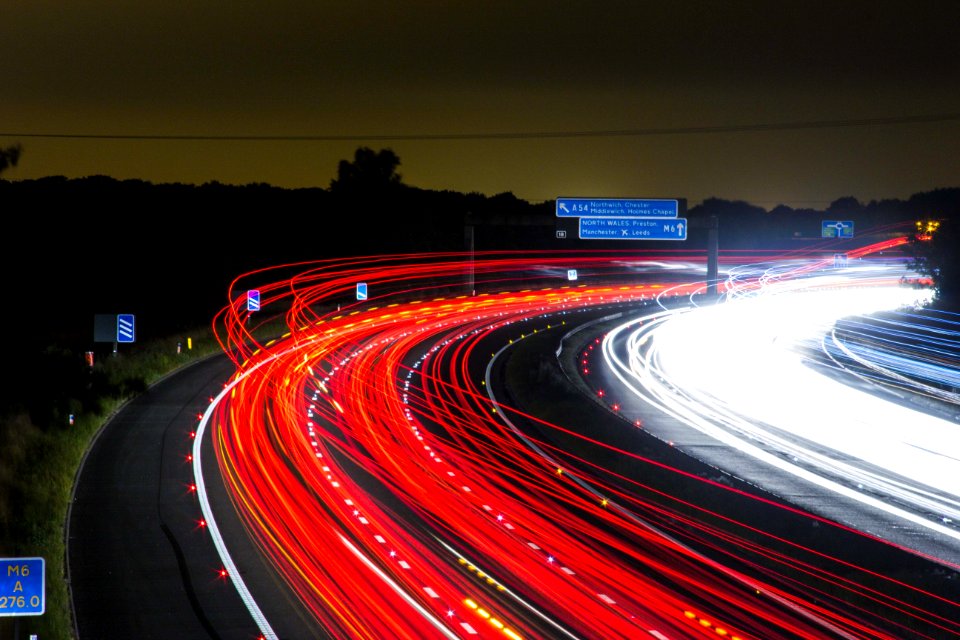 Time Lapse Photography Of Car Passing By The Winding Road During Nighttime