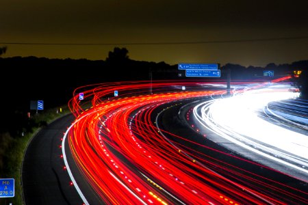 Time Lapse Photography Of Car Passing By The Winding Road During Nighttime photo