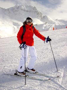 Woman In Red Jacket And White Pants On White Snow photo