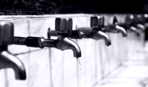 Water Drops From Stainless Steel Faucet photo