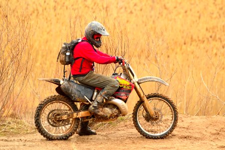 Man In Red Sweater Driving Dirt Bike photo