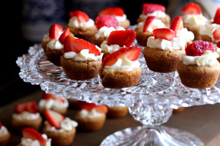 Cupcake With Strawberry Toppings On Clear Glass Cup Cake Rack photo
