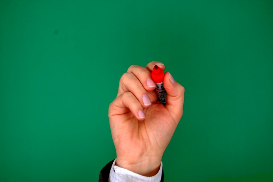 Person Holding Red Marker