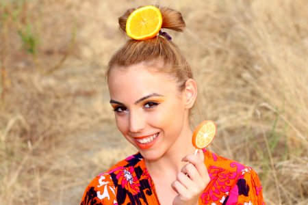 Portrait Of Woman With Orange In Hair