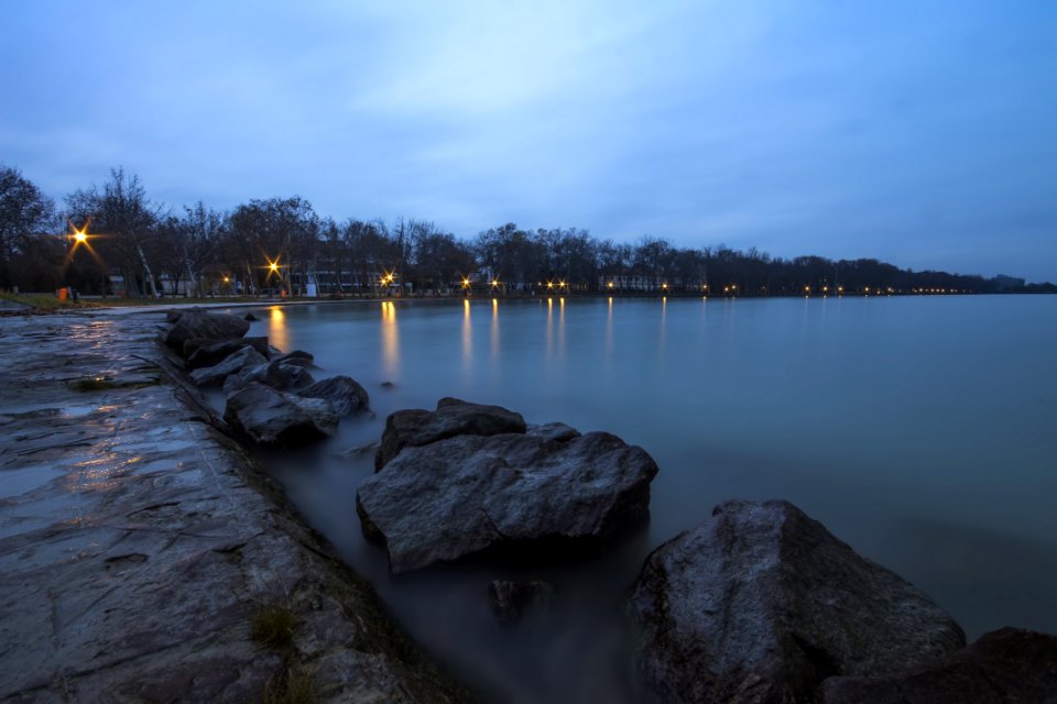 Large Rocks In Bay Under White And Blue Cloudy Sky