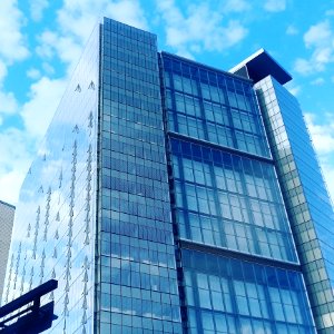 Low Angle View Of Glass High Rise Building During Cloudy Daytime Photo