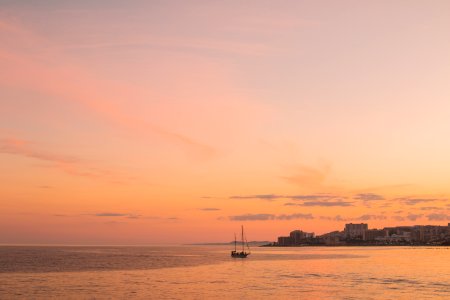 Boat Along Coastline At Sunset photo