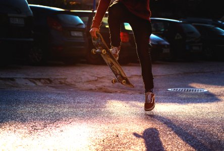 Person In Red Long Sleeved Shirt And Black Skinny Pants Riding A Skateboard photo