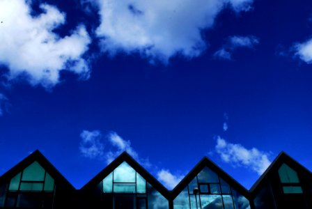 Grey Wood And Glass House Under Blue Sky And Clouds During Daytime photo