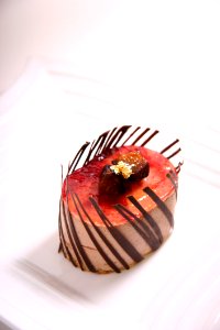 Red And Brown Oval Shape Chocolate Pastry On Ceramic Plate photo
