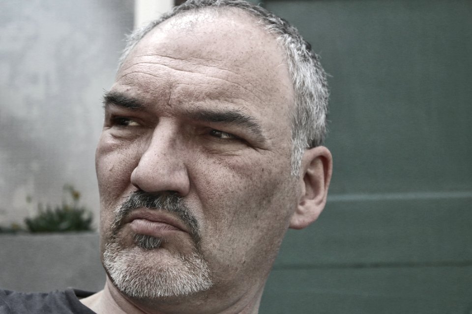 Man In Black Shirt Near Gray Wall