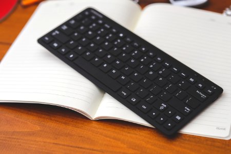 Black Desktop Wireless Keyboard On The Note photo