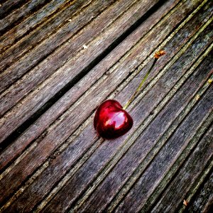 Red Cherry On Wooden Surface photo