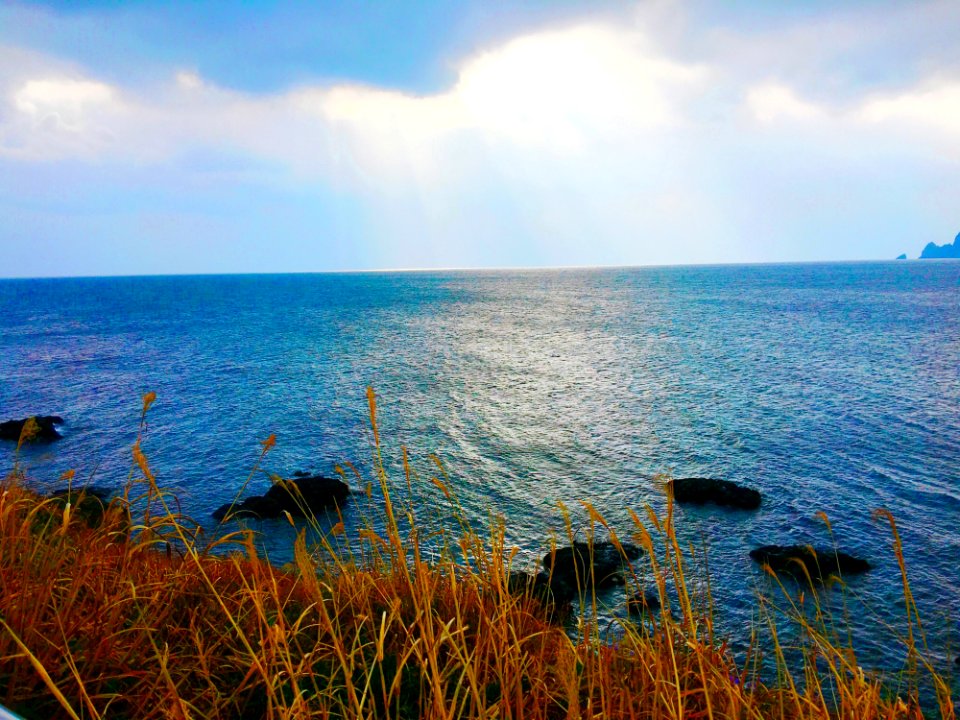 Stones In Sea Under Gray Sky During Daytime