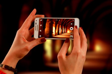 Woman Holding A White Samsung Galaxy Android Smartphone Taking A Photo Of Hallway photo