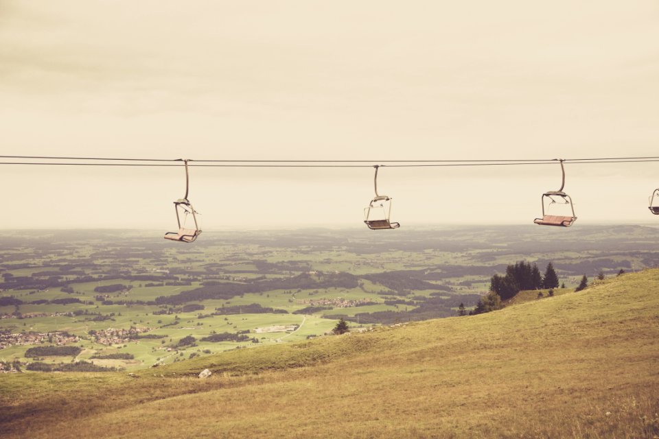Empty Ski Lift Passing By Mountain During Daytime