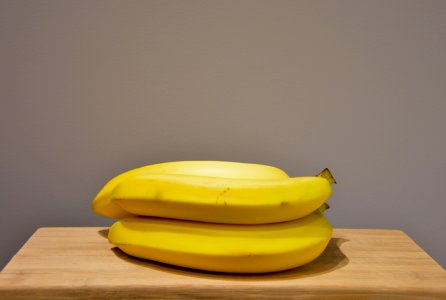 Yellow Bananas On An Oak Wood Table photo