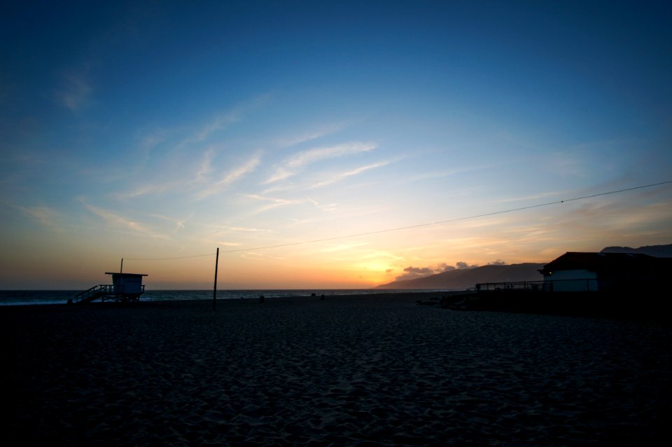 Seashore Under Blue Sky With Brown Clouds During Sunrise