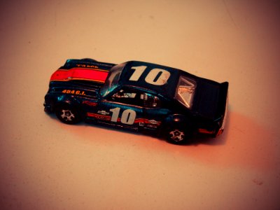 Teal Red And White Die Cast Model Of Racing Car