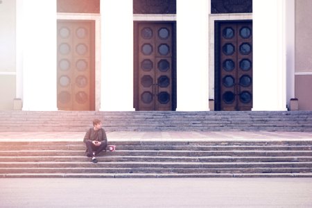 Man Sitting On A Concrete Stair Waiting For Someone During Daytime photo