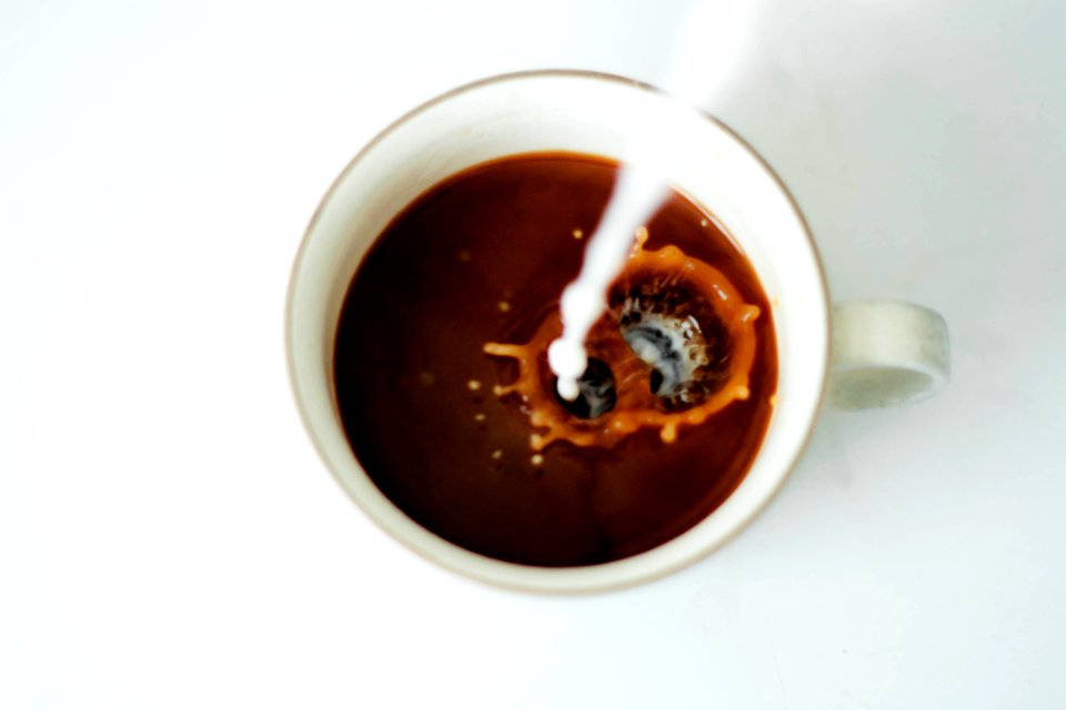 Milk Pouring Into Coffee