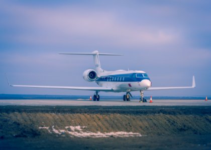 Blue And White Airplane On Concrete Ground photo