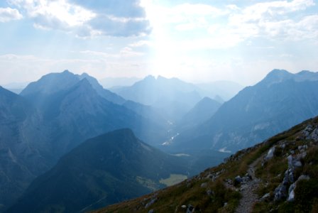 Green Grasses On Rocky Mountains Under Blue Sky photo