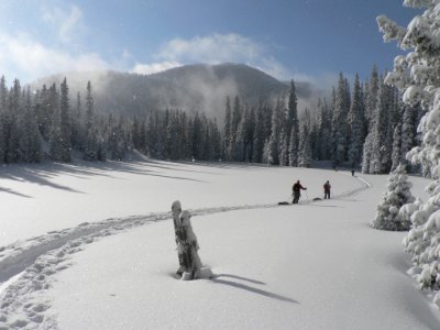 2 Person Walking On Snowfield During Daytime photo