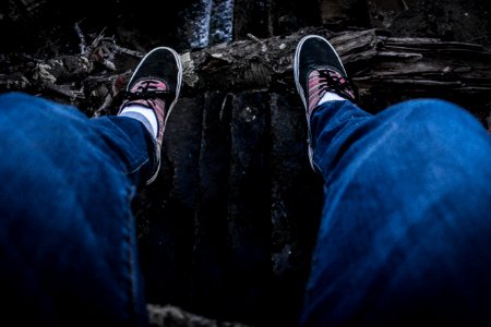 Person Wearing Blue Denim Jeans Above Black Surface