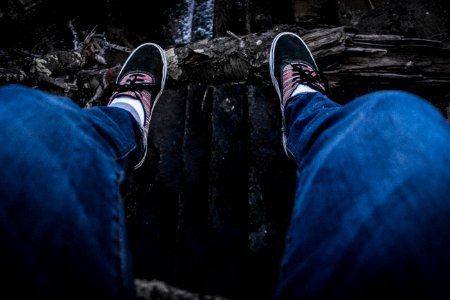 Person Wearing Blue Denim Jeans Above Black Surface photo