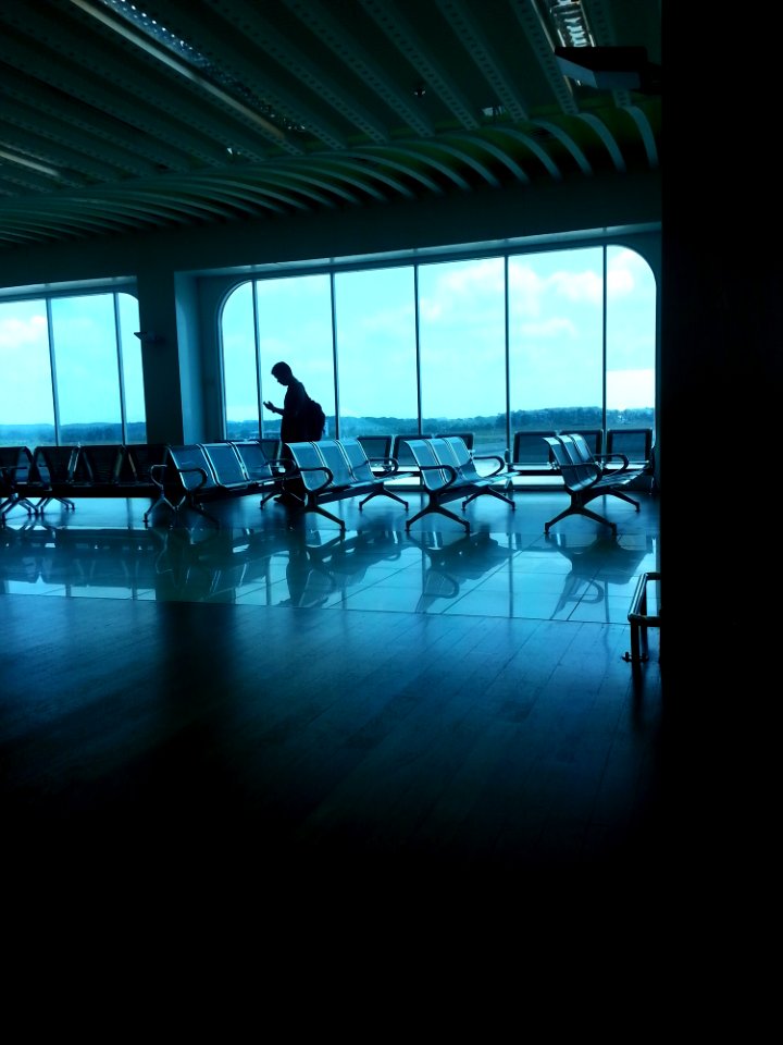 Grey Waiting Chairs And A Man photo