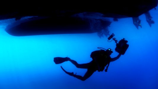 Scuba Diver Under Ship photo