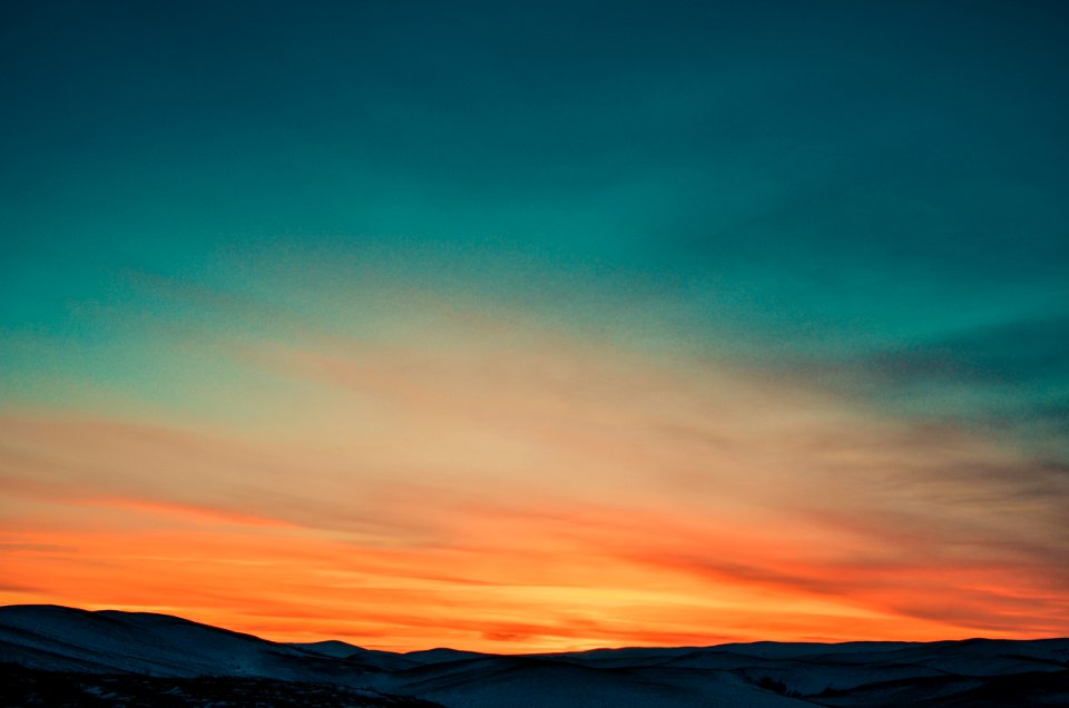 Sunset Over Snow Covered Mountains