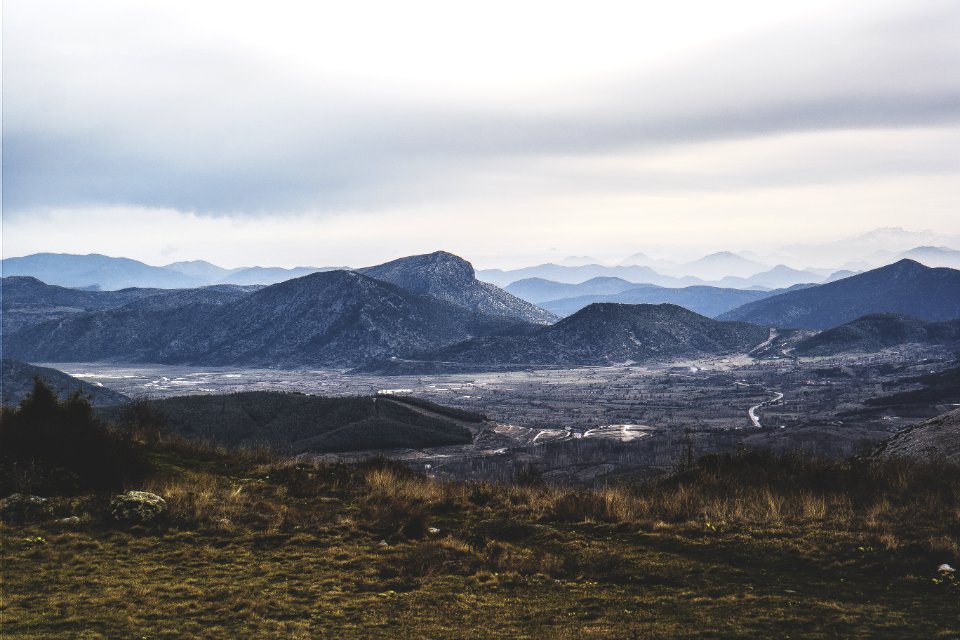 Gray Mountains And Brown And Green Weeds And Grass