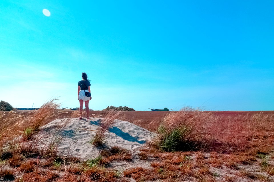 Young Woman Looking Out Over The Countryside
