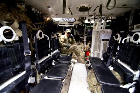 Man In Soldier Suit Sitting In Black Leather Seat
