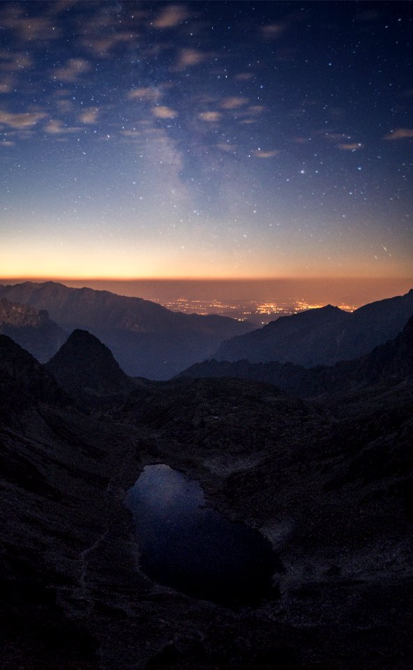 Crater Between Mountains Under Blue Sky White Clouds And Stars During Sunset