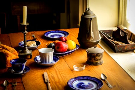 Blue And White Ceramic Plate Next To Apple Fruit And Brown Tea Pot photo