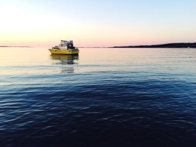 Boat On Waters At Sunset photo