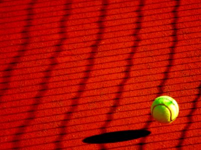 Green Tennis Ball On Red Floor During Sunny Day