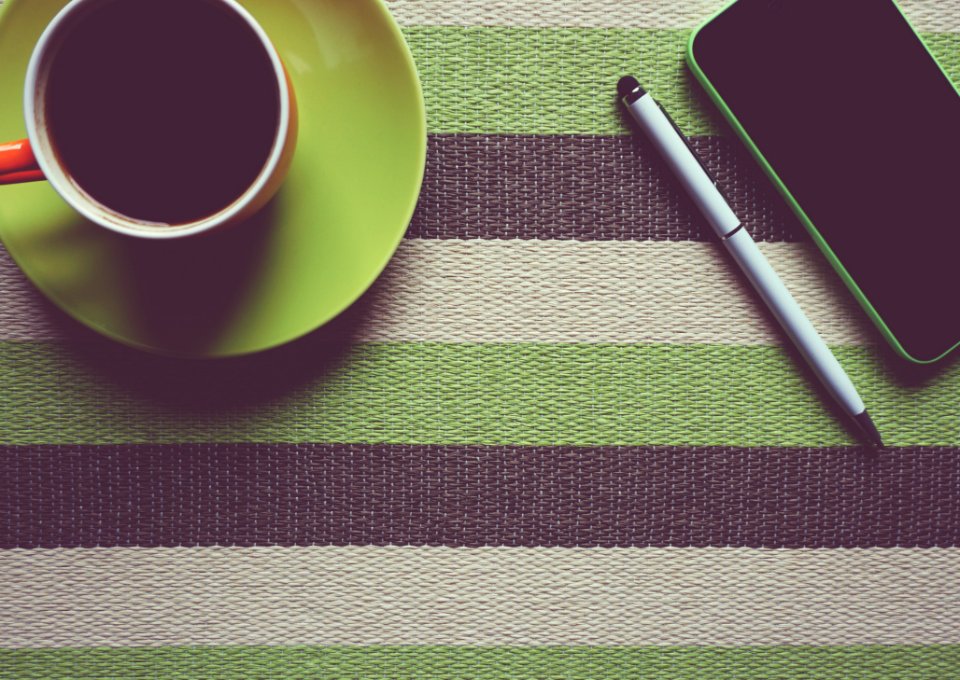 Green Iphone 5c Next To Coffee Mug