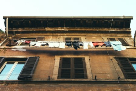 Hanging Clothes And Pants Beside Brown Building