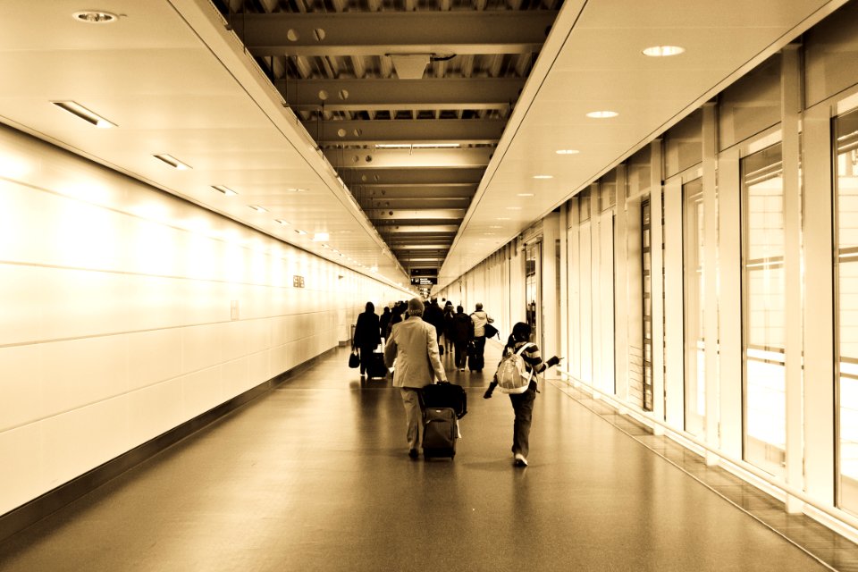 People Walking In The Hallway Inside The Building