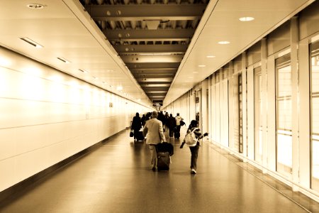 People Walking In The Hallway Inside The Building photo