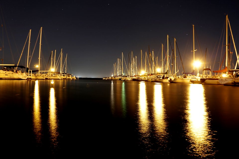 Sailboats Illuminated In Harbor