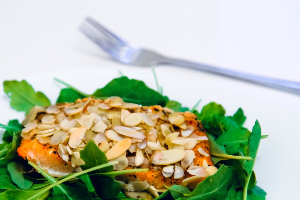 Green Leaf Covering Meat With Sesame Seeds With A Fork On The Side
