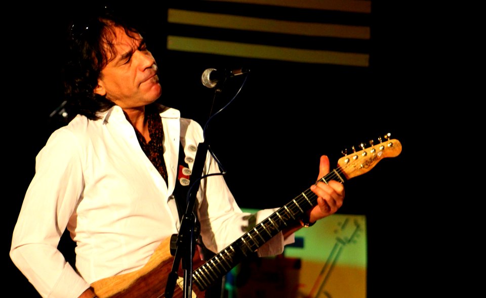 Man In White Playing Guitar